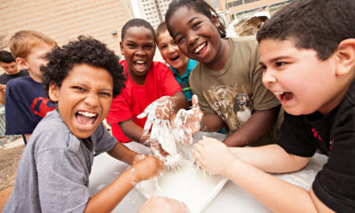 Children play with a goo-like fluid when water mixes with corn starch